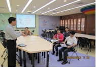 龍華科大企管系朱志忠主任(左1)為考察團貴賓展示創新與創意專業教室的特色與功能