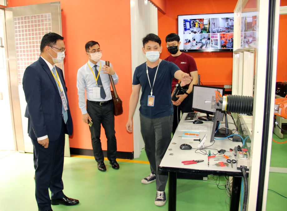 林明裕局長聽取學生機器人手備操作說明。