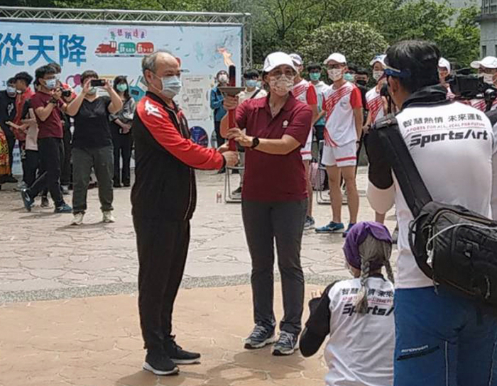 成大林麗娟學務長（右）將聖火交接給龍華科大葛自祥校長。